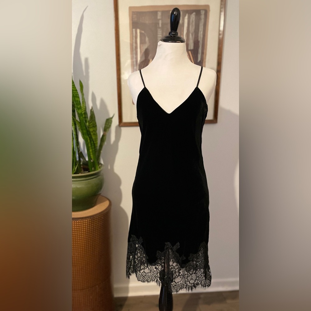 Slay in this stunning black velvet slip dress with lace hem. Dry clean only.